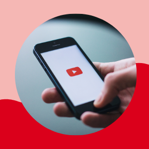 This image shows a person clicking on a smartphone to watch a YouTube video.