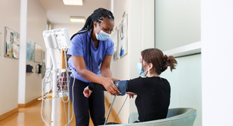 A nurse in St Patrick's University Hospital does a health check-up of a service user.