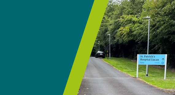 Photo of the entrance to the road leading to St Patrick's Hospital Lucan, showing a sign with the hospital name on the right hand side of the road