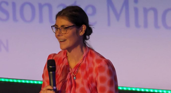 Photo of Dr Clodagh Dowling - Director of Psychology at St Patrick's Mental Health Services and an Adjunct Professor of Psychology - speaking on stage at a psychology conference.